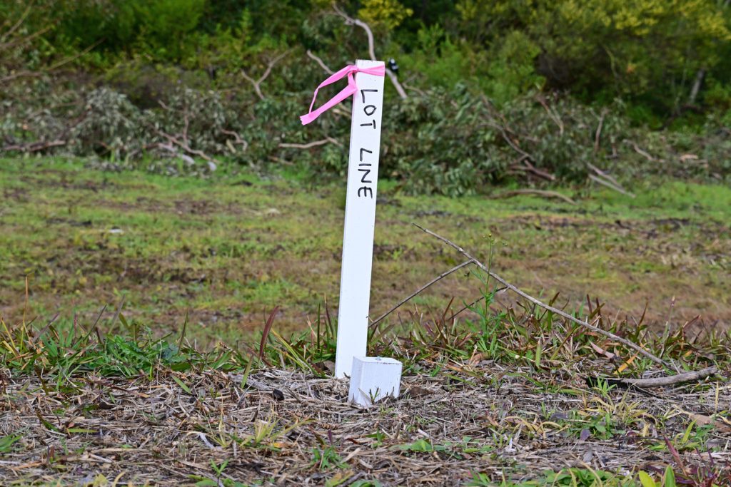 Pegging the title boundary for a Melbourne client by South East Land Surveyor to confirm the Title boundaries and fences are correct